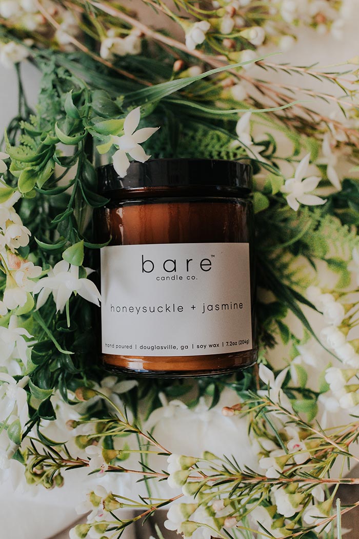 honeysuckle and jasmine soy candle on a bed of florals
